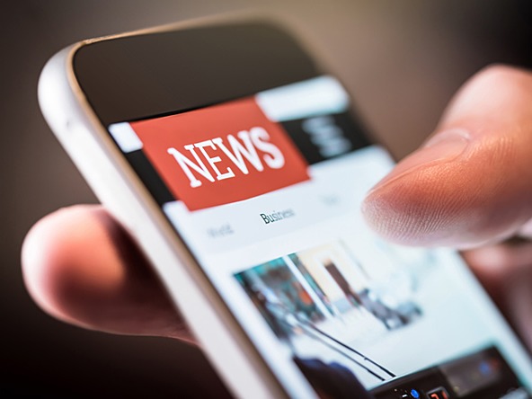 person reading news on phone screen